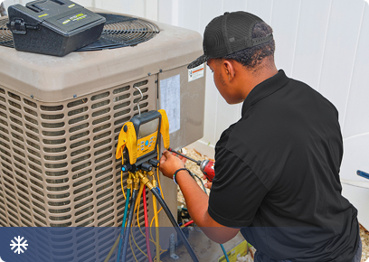 Drake-Cooling-CTA Drake Heating & Air technician checking pressures on an outdoor air conditioning unit, linking to cooling services